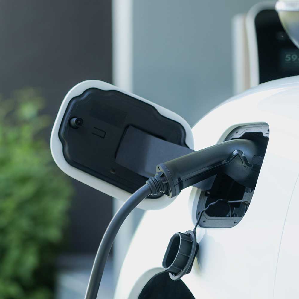 A close-up of an electric vehicle charging at a home EV charging point in Gloucestershire.