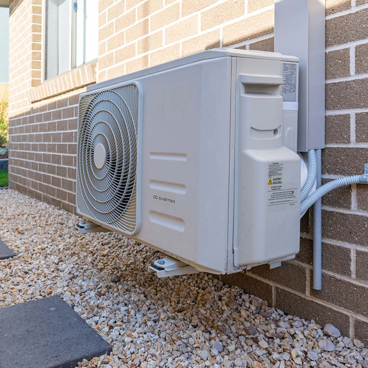 A neatly installed outdoor unit of a home air2air heat pump system