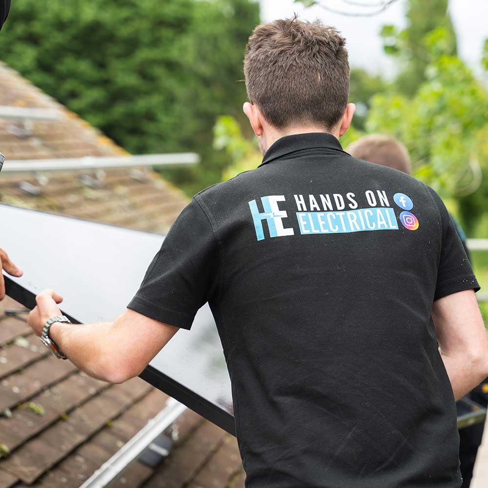 Hands On Electrical engineers installing a solar PV panel on a residential rooftop in Gloucestershire.