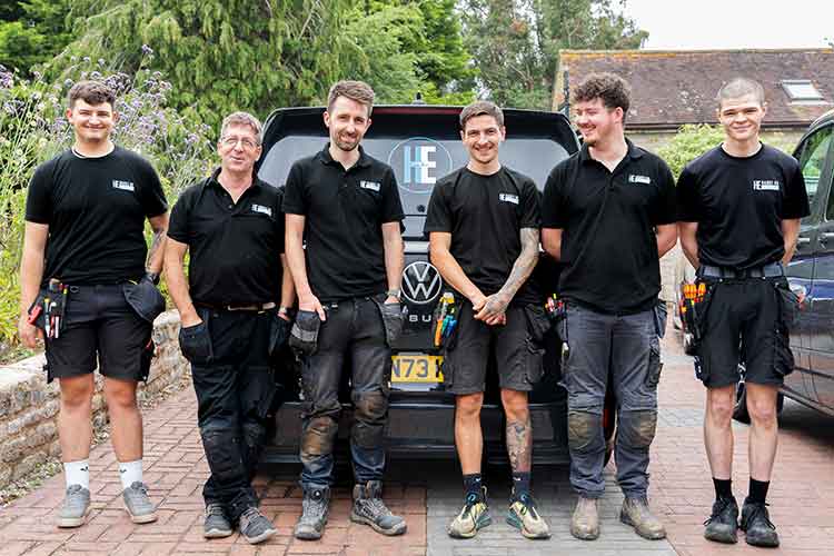 Six of the Hands On Electrical engineering team pictured on a residential driveway