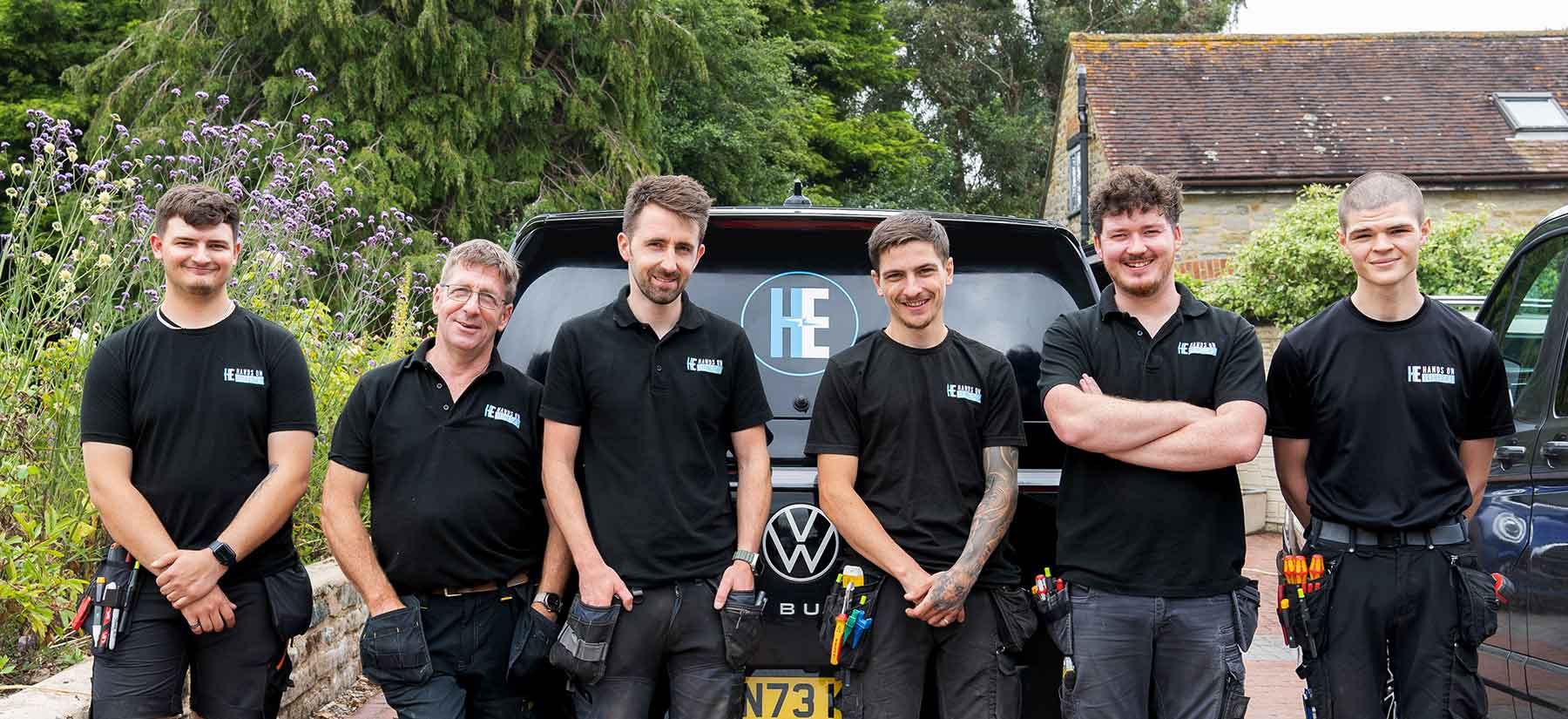 A smiling team of Hands On Electrical engineers